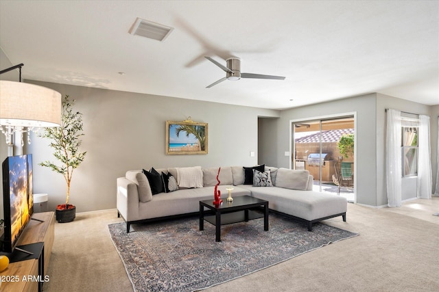 carpeted living room featuring ceiling fan