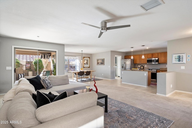 carpeted living room featuring ceiling fan