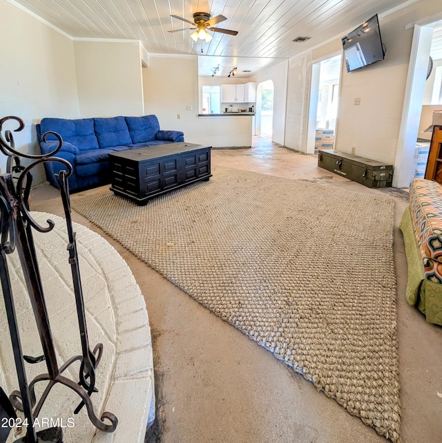 living room with ceiling fan, wood ceiling, and ornamental molding