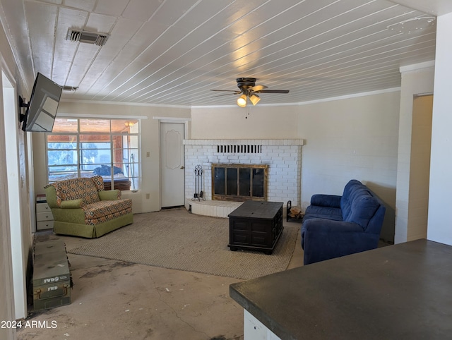 living room with unfinished concrete floors, visible vents, ceiling fan, ornamental molding, and a brick fireplace