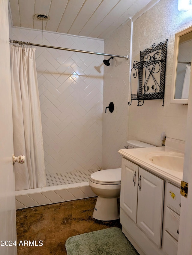 bathroom with vanity, toilet, and a tile shower