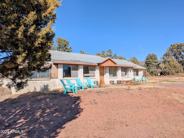 ranch-style house with roof with shingles