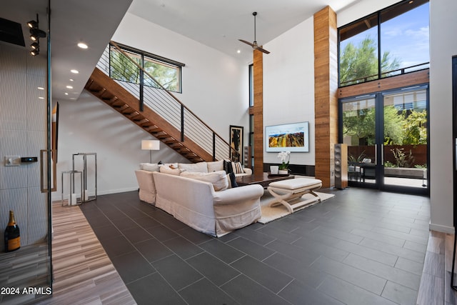 living room featuring a towering ceiling and dark hardwood / wood-style floors