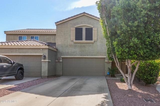 13540 N 87th Dr, Peoria, AZ 85381 - view of front facade featuring driveway, stucco siding, and an attached garage