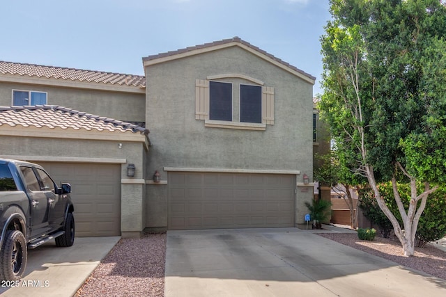 13540 N 87th Dr, Peoria, AZ 85381 - view of front of house with driveway, stucco siding, an attached garage, and a tile roof