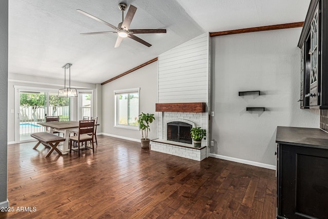 18820 N 33rd Ave, Phoenix, AZ 85027 - living area featuring plenty of natural light, vaulted ceiling, dark wood-style flooring, a brick fireplace, and a ceiling fan