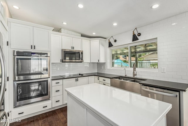 18820 N 33rd Ave, Phoenix, AZ 85027 - kitchen with stainless steel appliances, dark wood finished floors, decorative backsplash, white cabinets, and recessed lighting