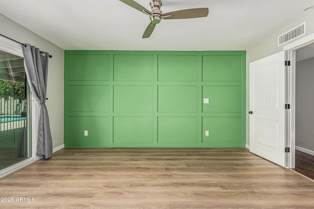 18820 N 33rd Ave, Phoenix, AZ 85027 - unfurnished bedroom featuring a decorative wall, wood finished floors, a ceiling fan, and access to exterior