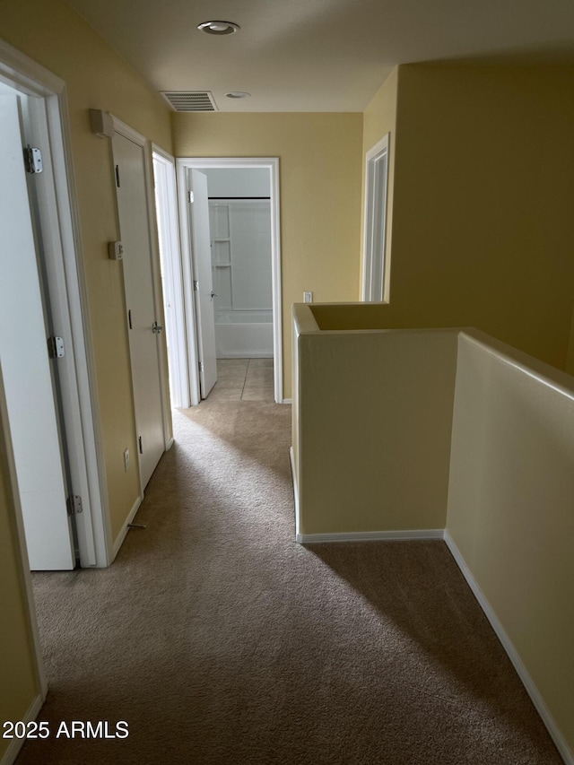 hallway with light colored carpet