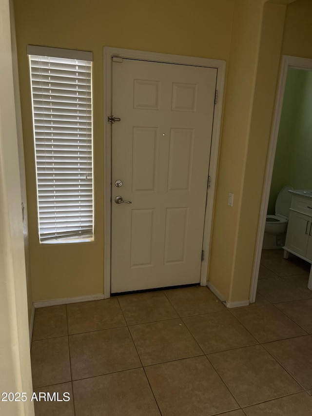 entryway with light tile patterned floors