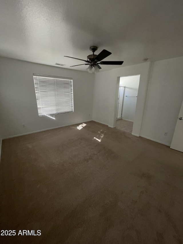 empty room featuring light colored carpet and ceiling fan