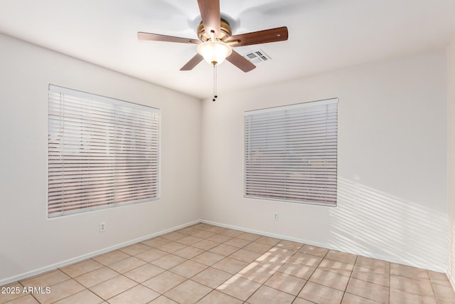 unfurnished room featuring baseboards, visible vents, and a ceiling fan