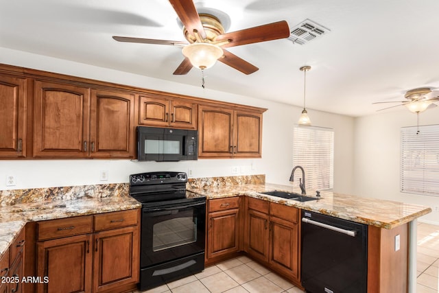 kitchen featuring visible vents, brown cabinetry, a sink, a peninsula, and black appliances