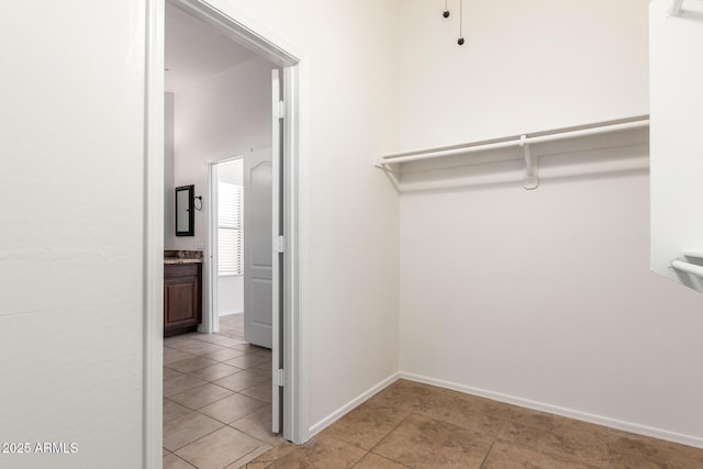 spacious closet with light tile patterned flooring