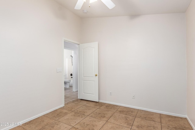 spare room with light tile patterned floors and ceiling fan