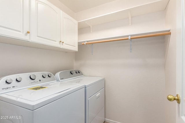 laundry area featuring cabinets and washer and clothes dryer