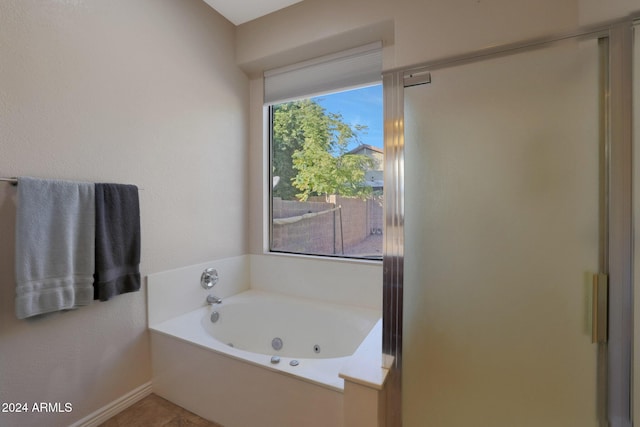 bathroom with tile patterned floors and independent shower and bath