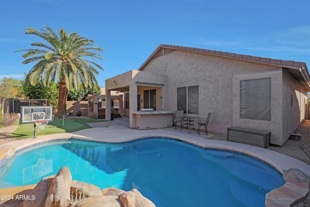 view of swimming pool with a patio area, area for grilling, and an outdoor bar