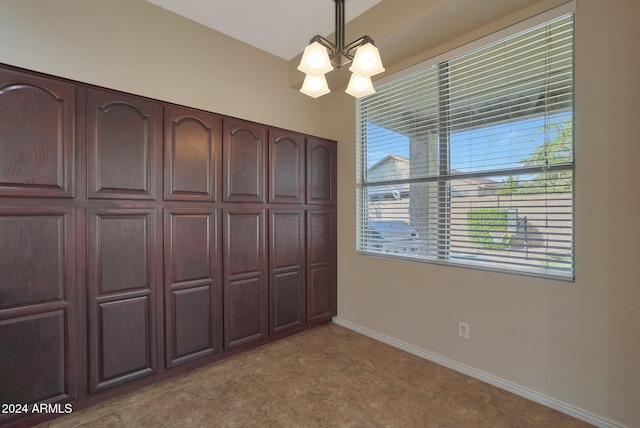 unfurnished bedroom with a chandelier