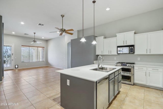 kitchen featuring white cabinetry, sink, a center island with sink, light tile patterned flooring, and appliances with stainless steel finishes