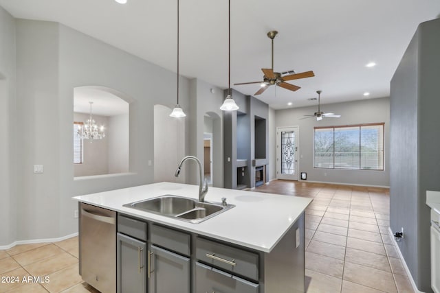 kitchen featuring a kitchen island with sink, dishwasher, light tile patterned flooring, and sink