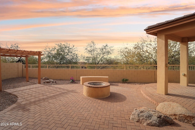 patio terrace at dusk with a pergola and a fire pit