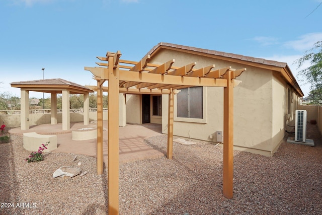 rear view of house with a patio area and a pergola