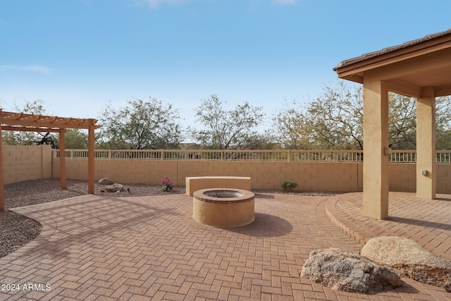 view of patio / terrace with a pergola and an outdoor fire pit