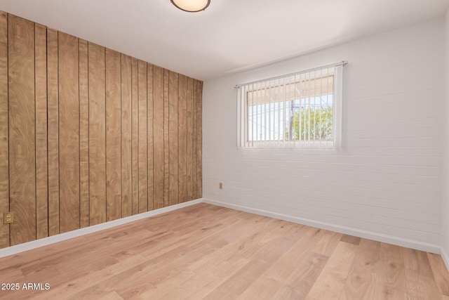 10012 N 16th Dr, Phoenix, AZ 85021 - unfurnished room featuring baseboards, wood finished floors, and wood walls