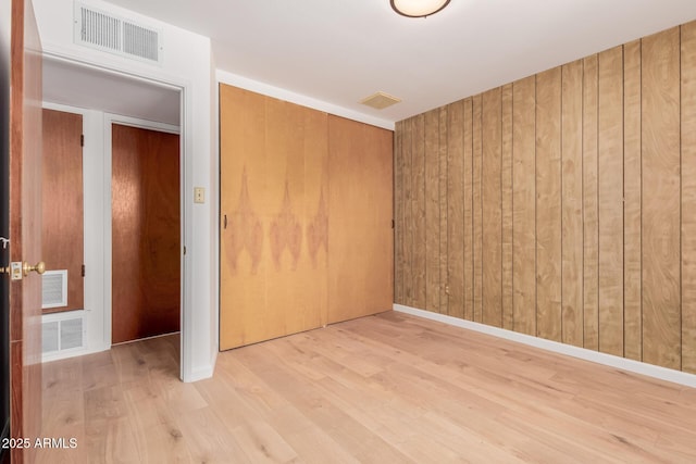 10012 N 16th Dr, Phoenix, AZ 85021 - unfurnished bedroom featuring a closet, wood finished floors, and wooden walls