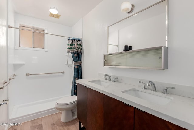 10012 N 16th Dr, Phoenix, AZ 85021 - full bath with curtained shower, toilet, wood finished floors, and double vanity