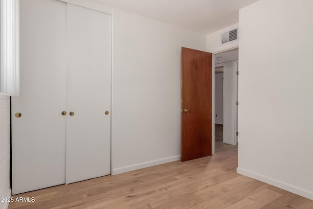 10012 N 16th Dr, Phoenix, AZ 85021 - unfurnished bedroom with a closet, light wood-type flooring, and baseboards