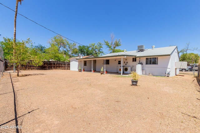 10012 N 16th Dr, Phoenix, AZ 85021 - back of property featuring a storage shed, a fenced backyard, an outbuilding, central AC unit, and a patio area