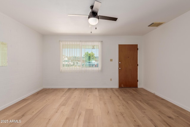 10012 N 16th Dr, Phoenix, AZ 85021 - spare room featuring light wood-style floors, ceiling fan, baseboards, and brick wall