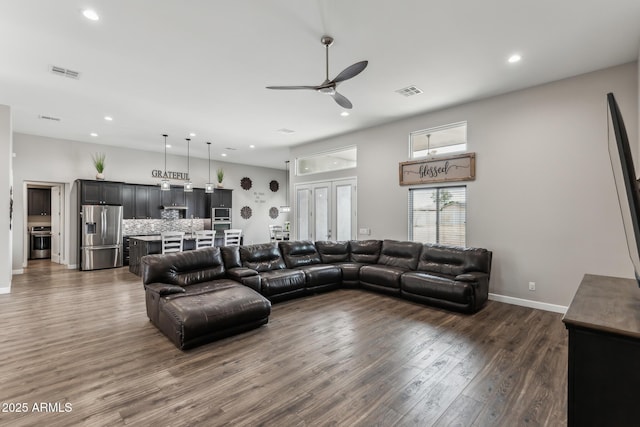 living room with ceiling fan and dark wood-type flooring