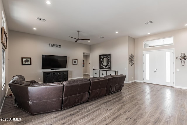 living room with ceiling fan and hardwood / wood-style flooring