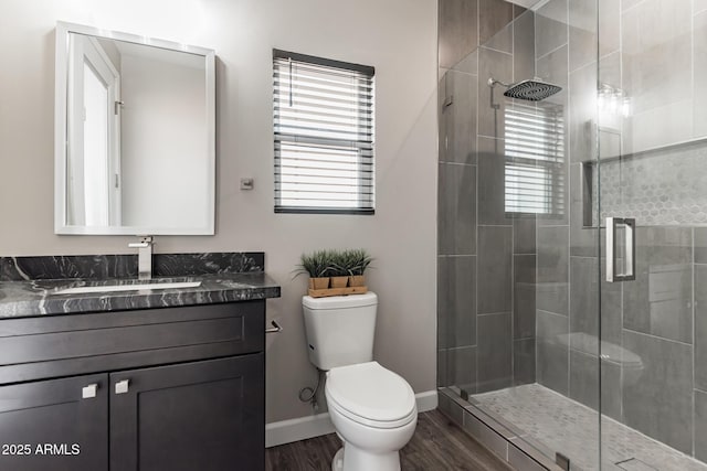 bathroom with hardwood / wood-style floors, vanity, toilet, and an enclosed shower