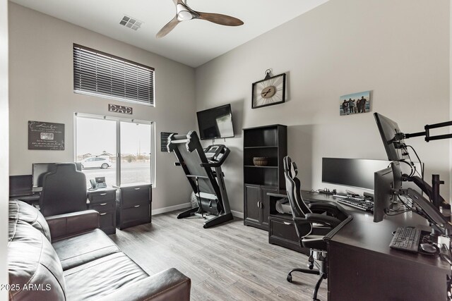 home office featuring ceiling fan and light hardwood / wood-style flooring