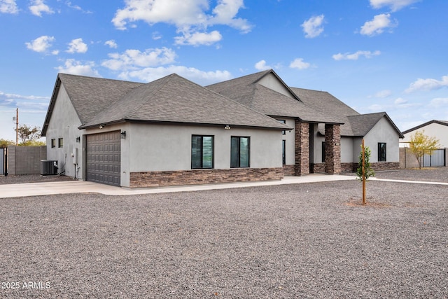 view of front of house featuring a garage and central AC unit