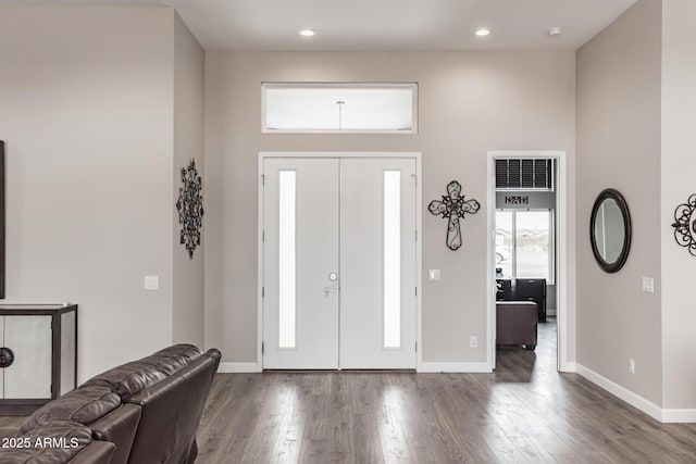 foyer with hardwood / wood-style floors and a high ceiling