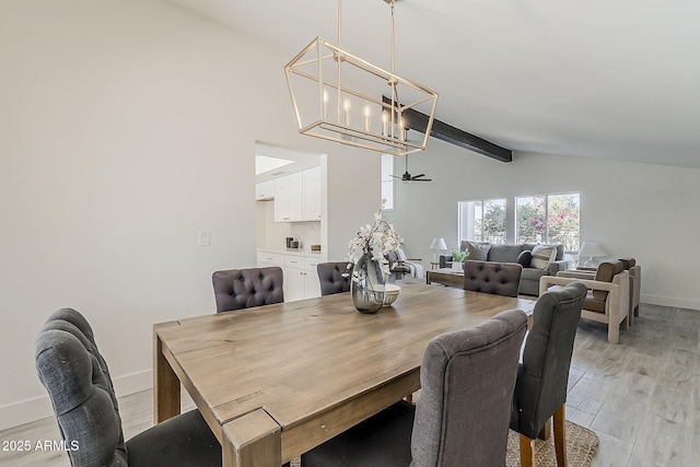 dining area with light wood-style flooring, an inviting chandelier, high vaulted ceiling, beamed ceiling, and baseboards