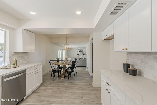 kitchen featuring visible vents, dishwasher, and white cabinetry