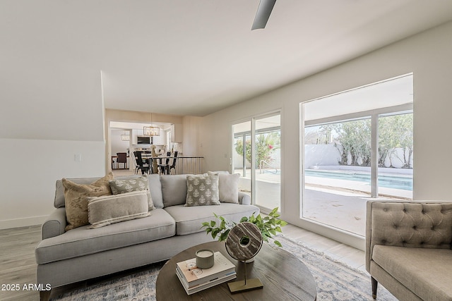 living room with baseboards and light wood-style floors