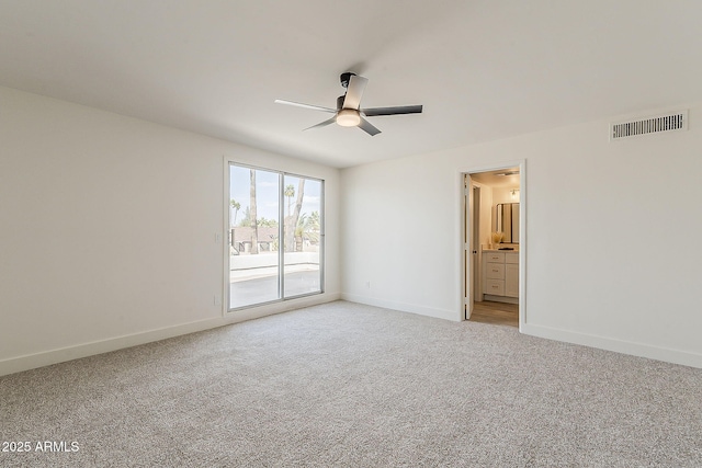 empty room featuring light carpet, ceiling fan, visible vents, and baseboards