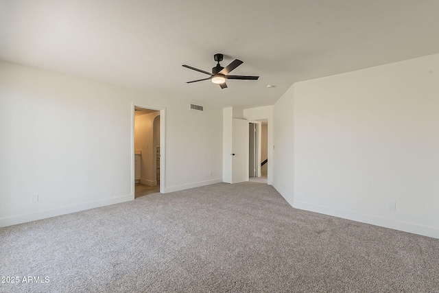 unfurnished bedroom featuring baseboards, ceiling fan, visible vents, and light colored carpet