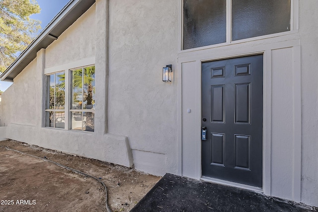 property entrance featuring stucco siding