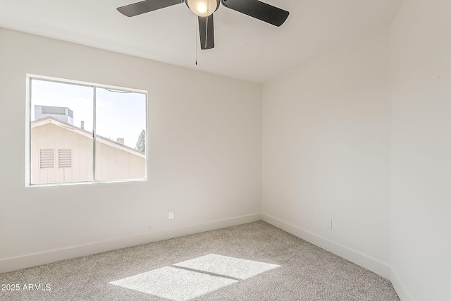 empty room with ceiling fan, carpet, and baseboards