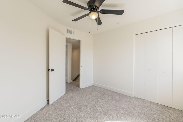 unfurnished bedroom with baseboards, visible vents, a ceiling fan, carpet flooring, and a closet