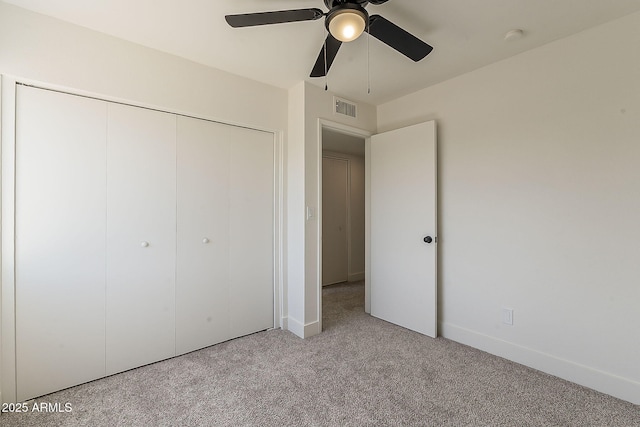 unfurnished bedroom featuring ceiling fan, carpet flooring, visible vents, baseboards, and a closet