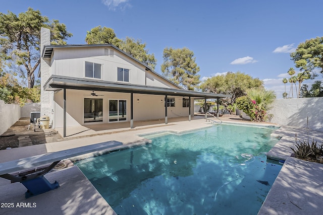 rear view of house featuring ceiling fan, a patio, a fenced backyard, and a fenced in pool